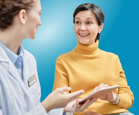 A dentist and patient discussing oral health together.